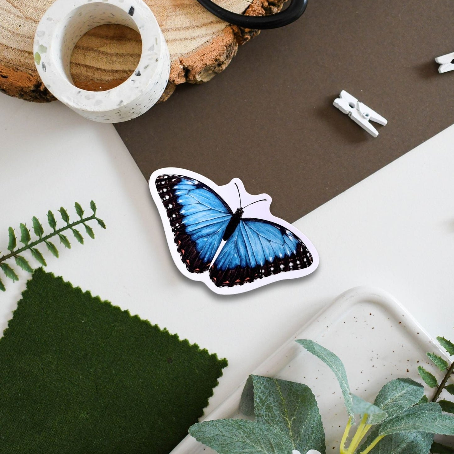Butterfly-shaped sticker on a surface with natural elements