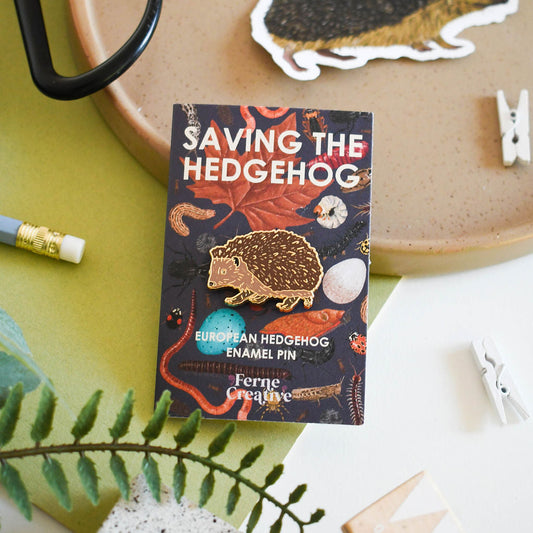 Ferne Creative packaging for 'Saving the Hedgehog' enamel pin with a hedgehog illustration.