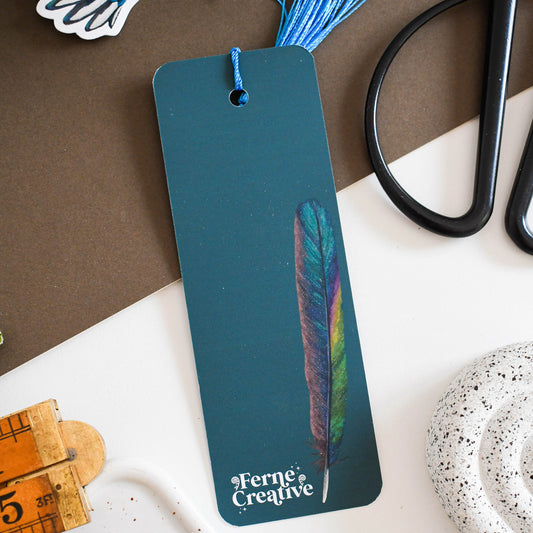 Bookmark with feather design on a table with stationery items