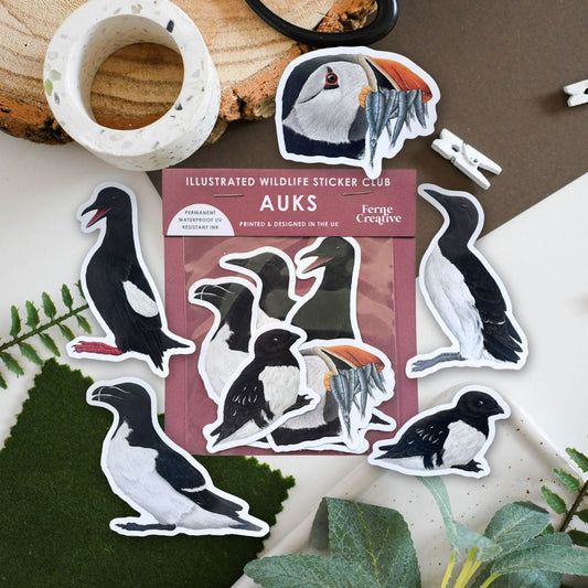 Illustrated wildlife sticker club for auks with penguin stickers on a natural background