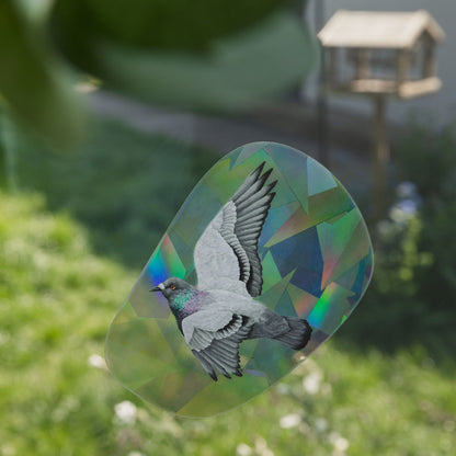 Decorative glass panel with a bird design in a garden setting