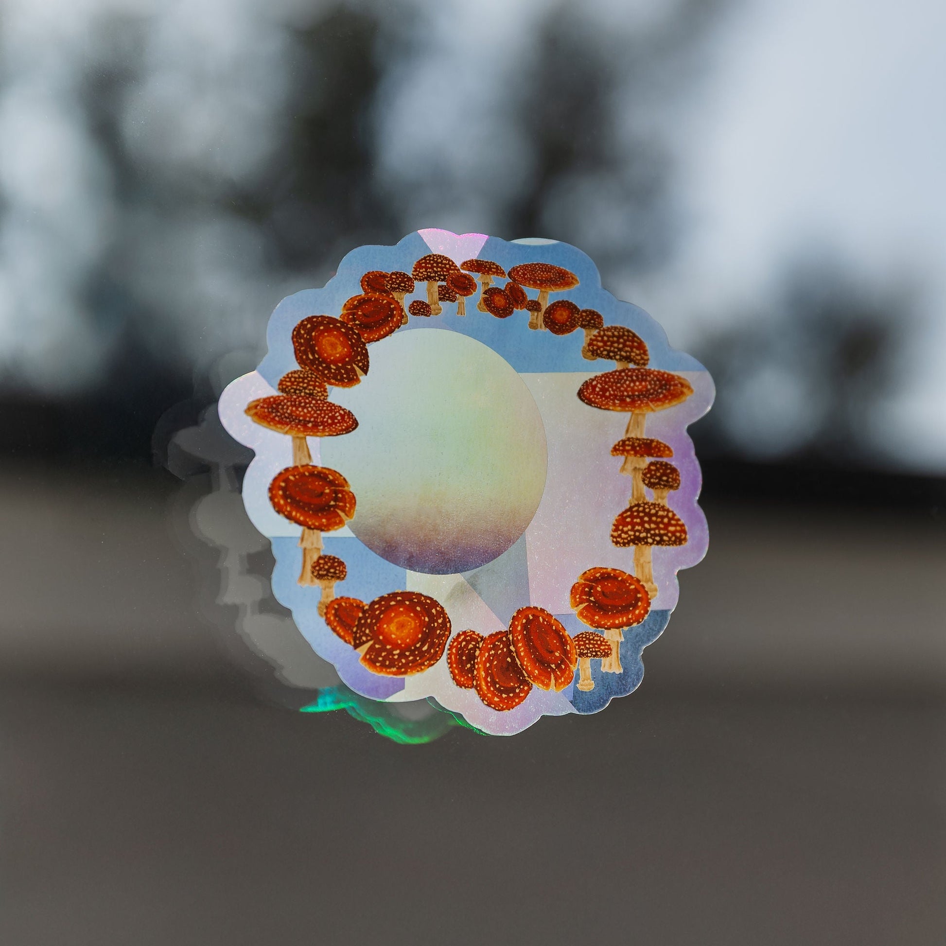 Holographic sticker with mushroom design on a blurred background