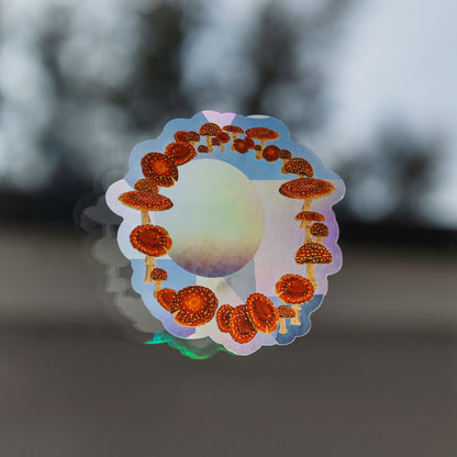 Holographic sticker with mushroom design on a blurred background