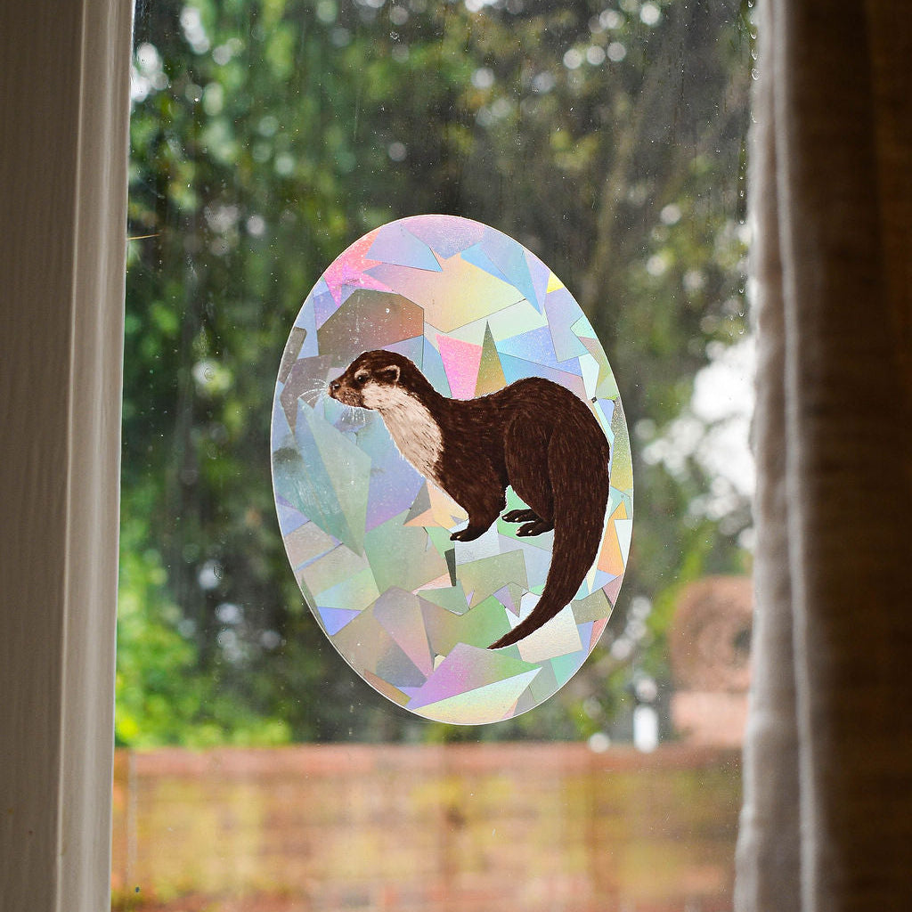 Eurasian Otter rainbow suncatcher decal backlit on window