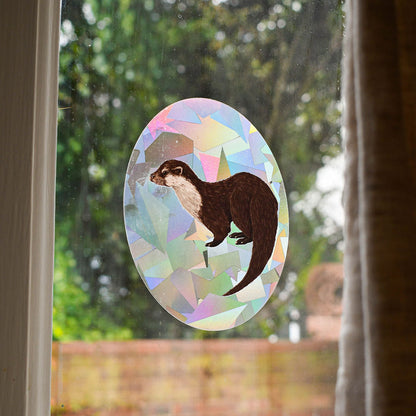 Eurasian Otter rainbow suncatcher decal backlit on window