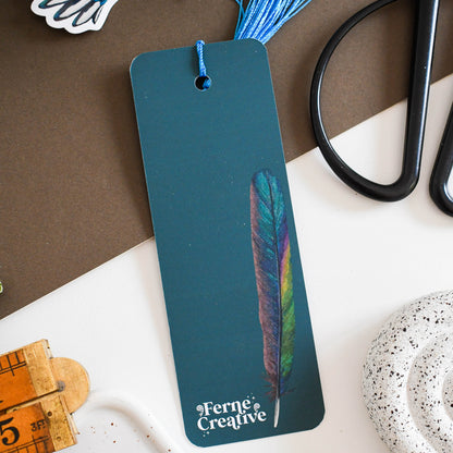 Bookmark with feather design on a table with stationery items