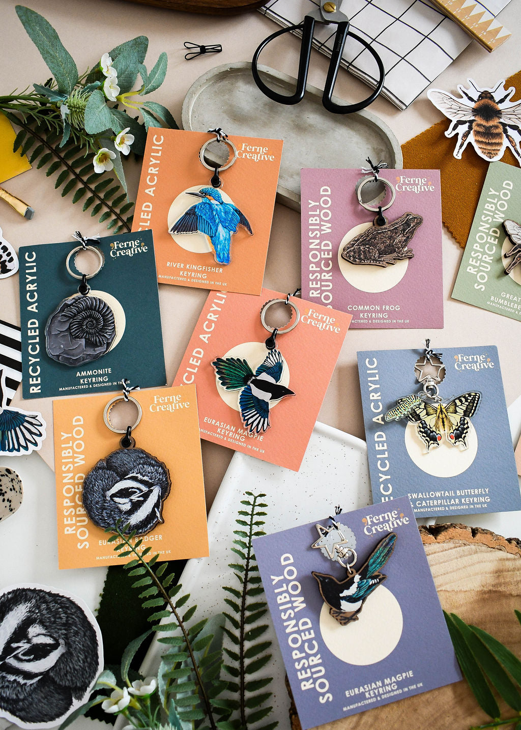 A selection of nature and wildlife illustrated keyrings on recycled materials with colourful backing cards